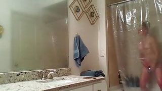 Voyeur girl taking photos and masturbating in the shower